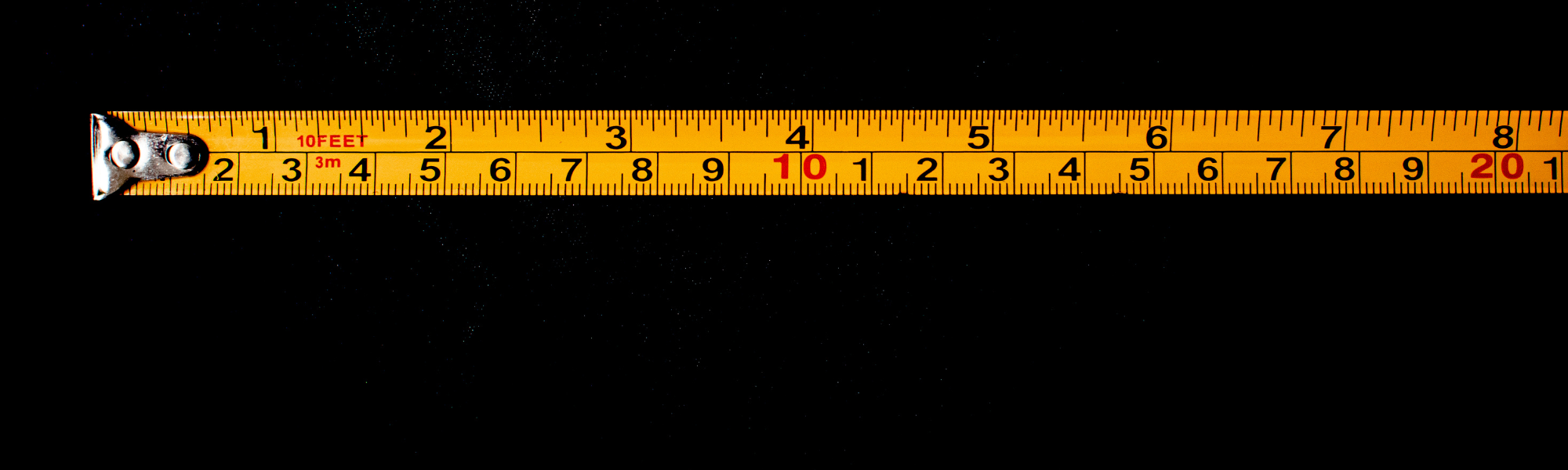 Measuring tape on a black background.