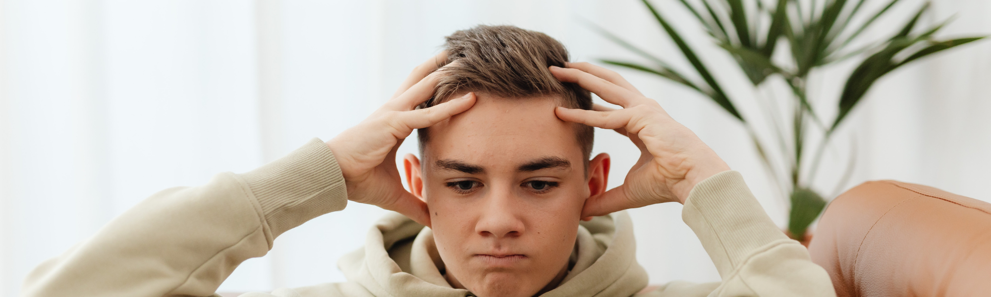 A man looks frustratedly at something off camera and below the screen. He has his hands in the "surrender cobra" except not clasped behind his head.
